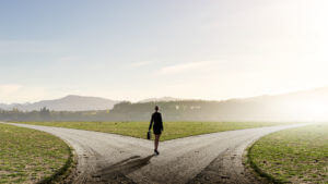 Man looking at two paths representing how to choose the right rehab