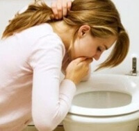 A woman who vomits at the toilet.